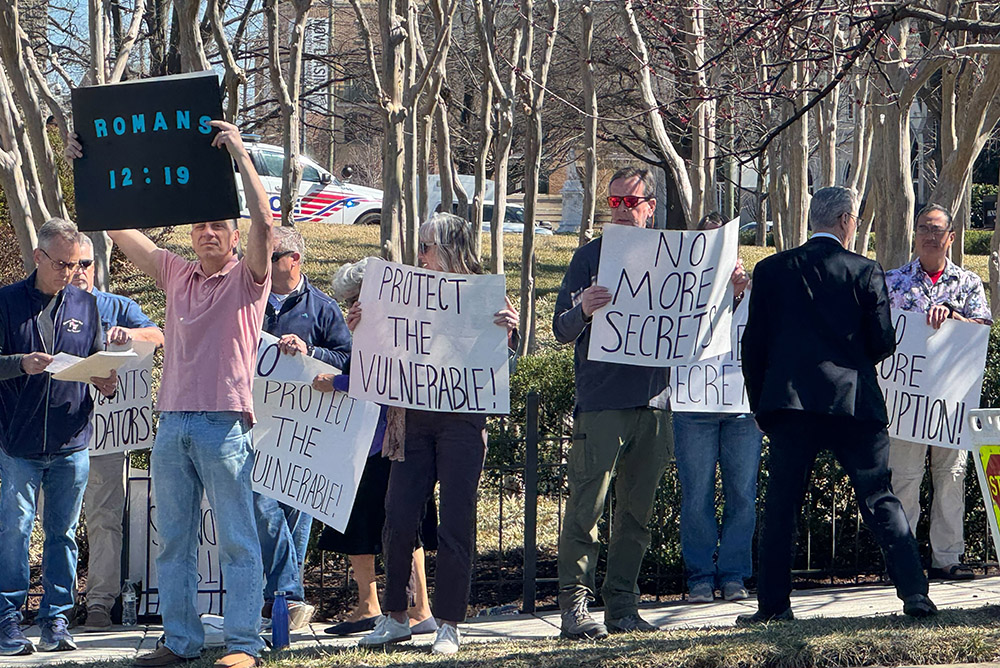 A group of protestors gather outside the Basilica of the Shrine of the Immaculate Conception prior to Washington Cardinal Robert McElroy's installation Mass March 11. (NCR photo/Rhina Guidos)